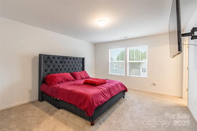 a bed sitting in a bedroom next to a window