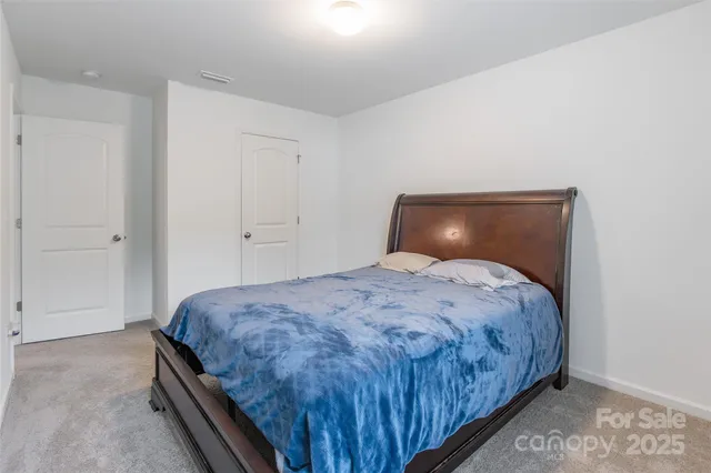 a bedroom with a bed and closet