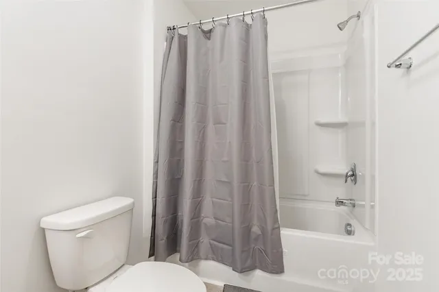 a bathroom with a toilet and shower