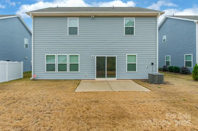 a view of a house with pool and sitting area