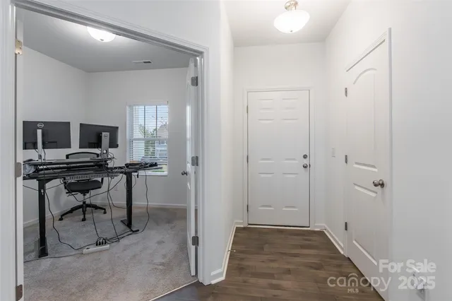 a view of a workspace with furniture and a window