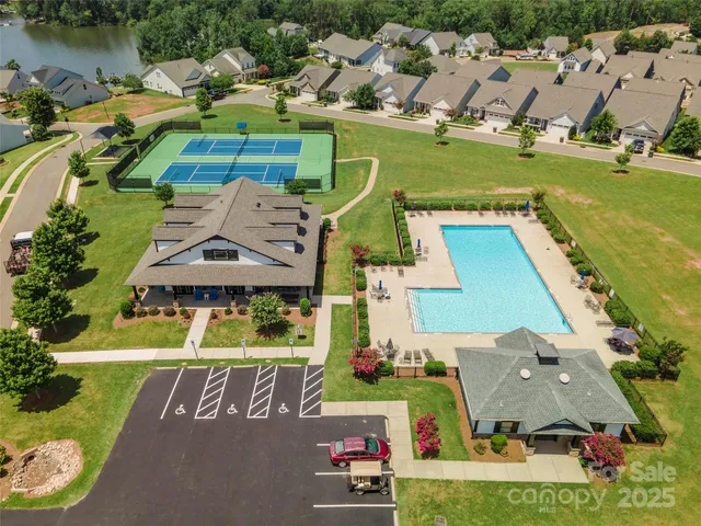 an aerial view of a house with a garden and lake view