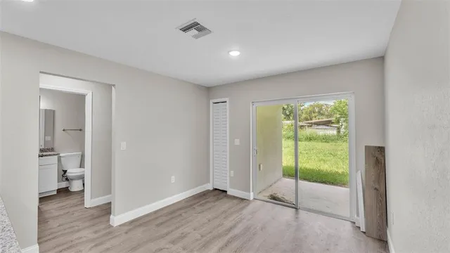 a view of an empty room with glass door