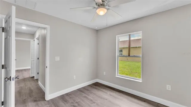 wooden floor in an empty room and a bathroom