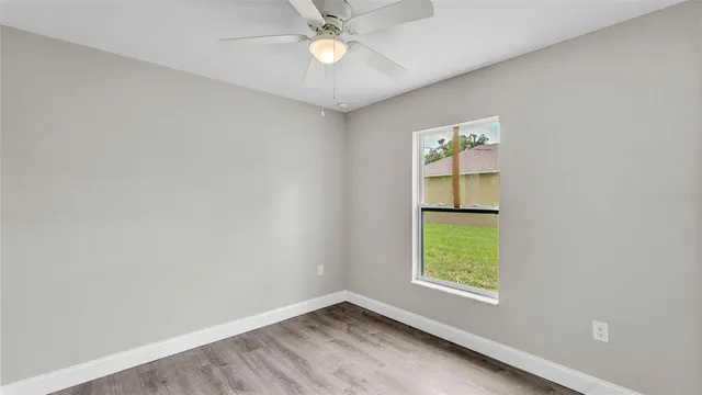 an empty room with windows and closet