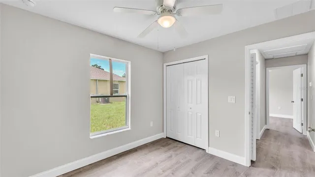 an empty room with closet and windows