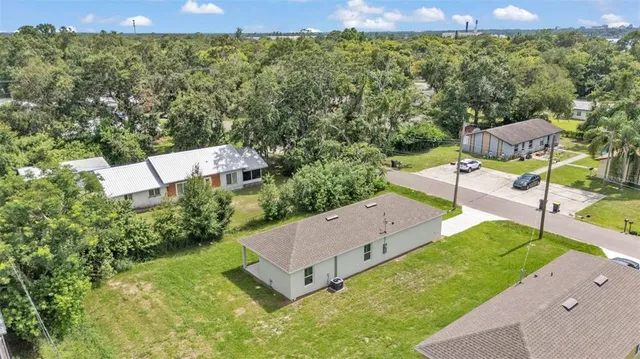 an aerial view of a house with swimming pool garden and mountain view