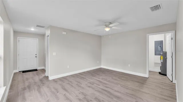 wooden floor in an empty room with a window