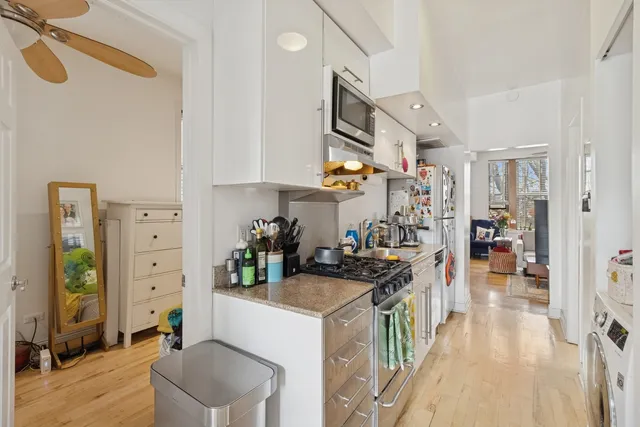 a kitchen with a sink appliances and cabinets