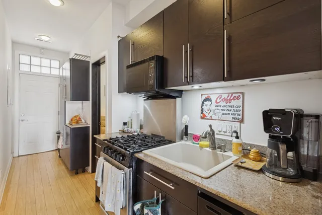 a kitchen with a sink stove and refrigerator