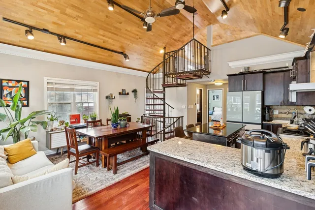 a living room with fireplace furniture and a potted plant
