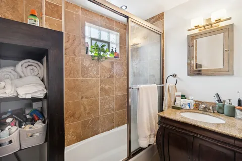 a bathroom with a sink a mirror and a shower