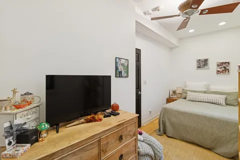 a bedroom with a bed and flat screen tv