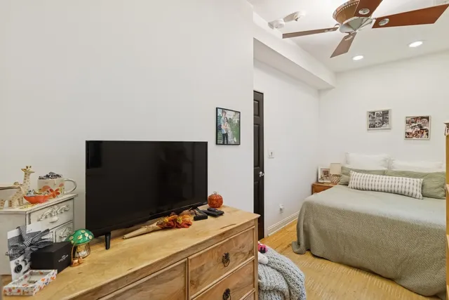 a bedroom with a bed and flat screen tv