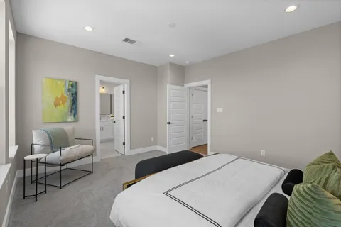 a bedroom with a bed and couch