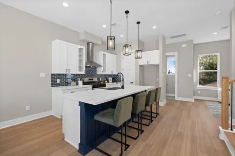 a kitchen with stainless steel appliances kitchen island a large island in the center