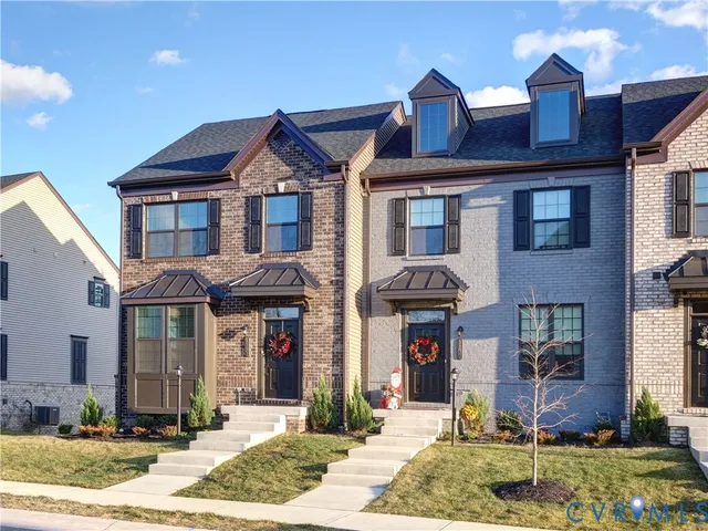 a front view of a residential apartment building with a yard