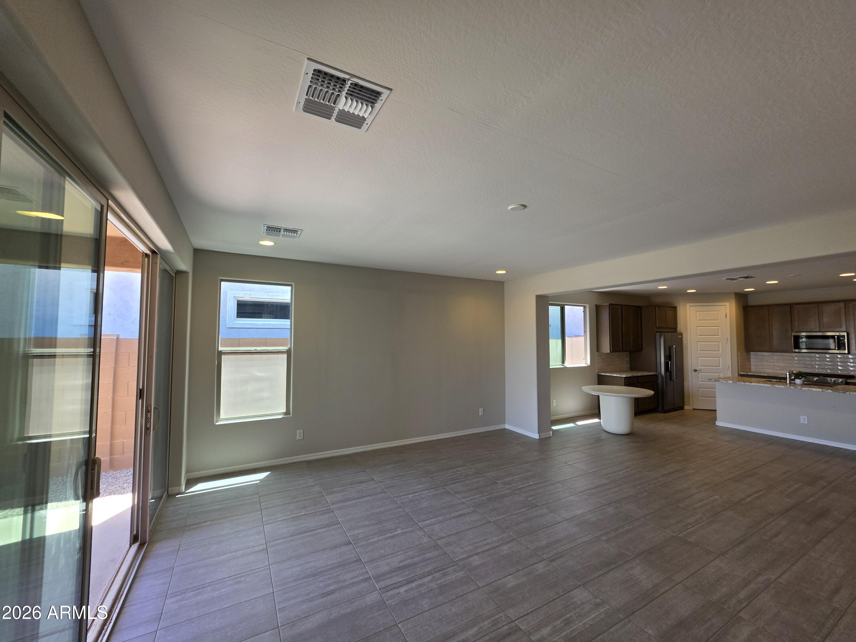7128 West Coles Road Laveen, AZ 85339 - Photo 8 of 38 a view of a livingroom with furniture wooden floor and a window
