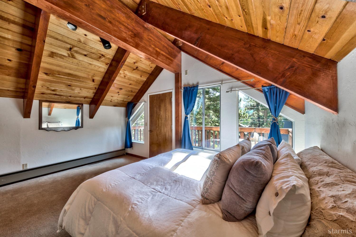 2004 Kickapoo Street South Lake Tahoe, CA 96150 - Photo 12 of 20 a bed sitting in a bedroom next to a window