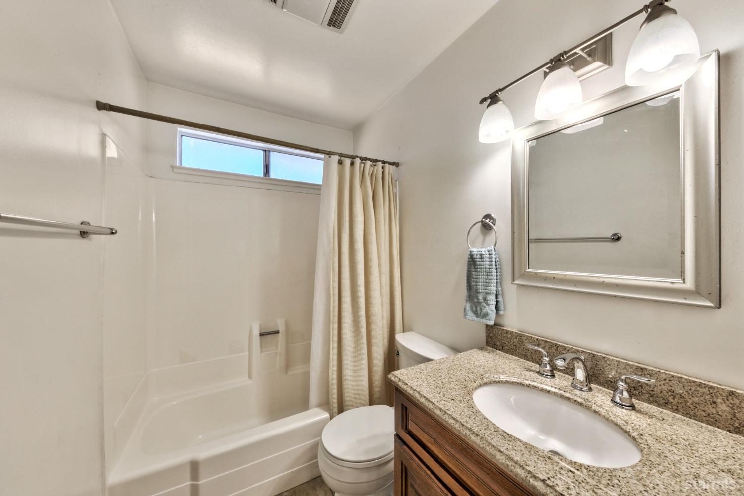 2004 Kickapoo Street South Lake Tahoe, CA 96150 - Photo 18 of 20 a bathroom with a granite countertop sink toilet and shower
