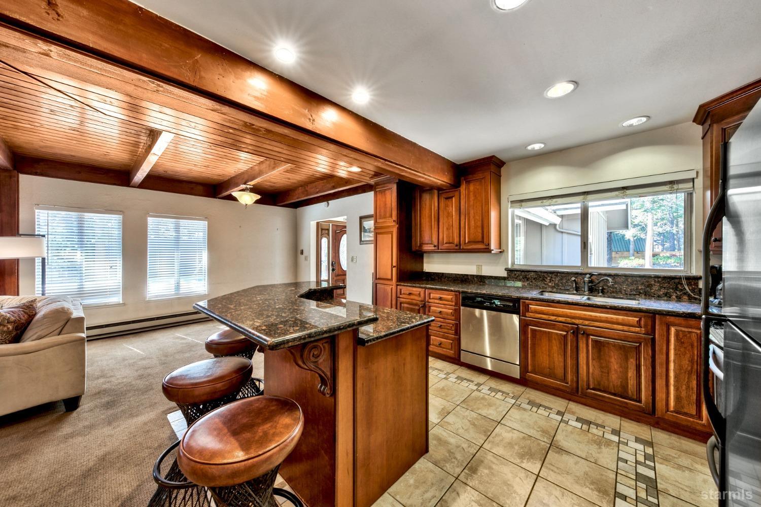 2004 Kickapoo Street South Lake Tahoe, CA 96150 - Photo 8 of 20 a kitchen with stainless steel appliances granite countertop a stove a sink and a microwave