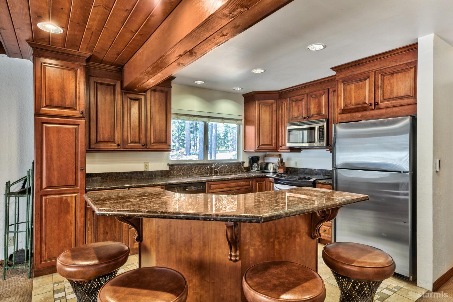 2004 Kickapoo Street South Lake Tahoe, CA 96150 - Photo 10 of 20 a kitchen with stainless steel appliances granite countertop a sink and a refrigerator