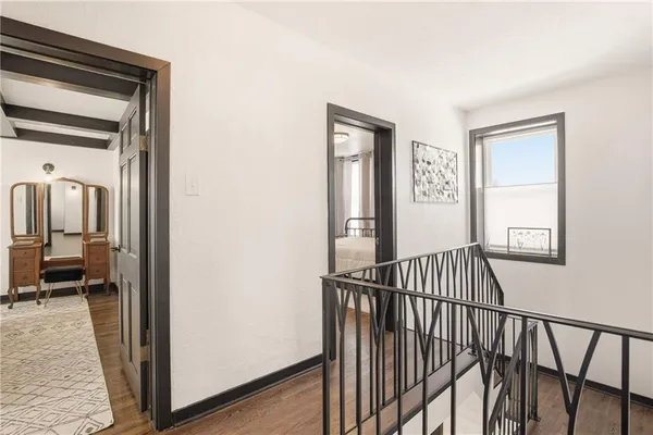 a bedroom with a bed next to a window and a chair