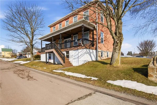 a view of a house with snow on the road