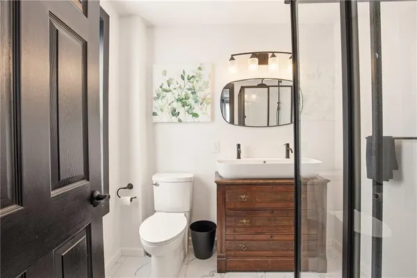 a bathroom with a shower and a sink