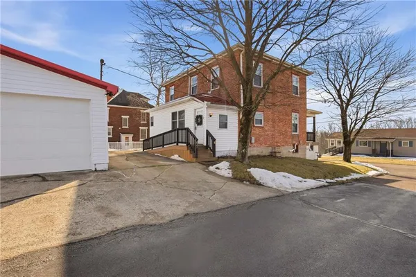a view of a house with a wooden fence