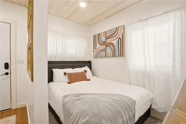 a bathroom with a granite countertop sink a toilet and a shower