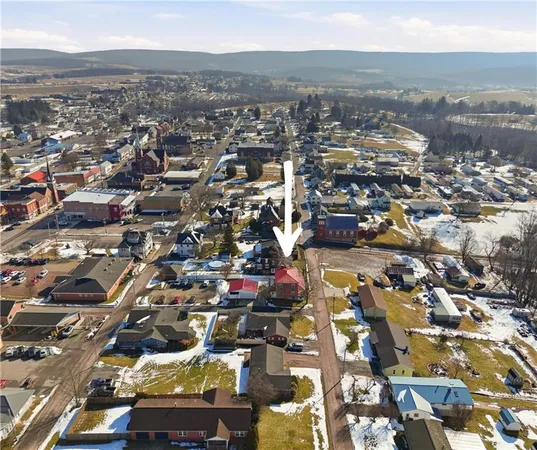 an aerial view of residential building with parking