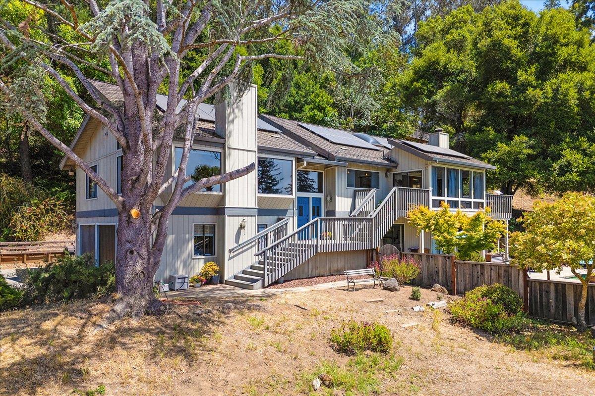 a view of a house with a tree in the yard