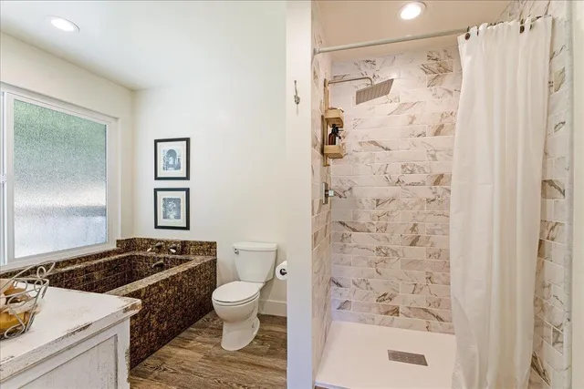 a bathroom with a sink toilet and shower