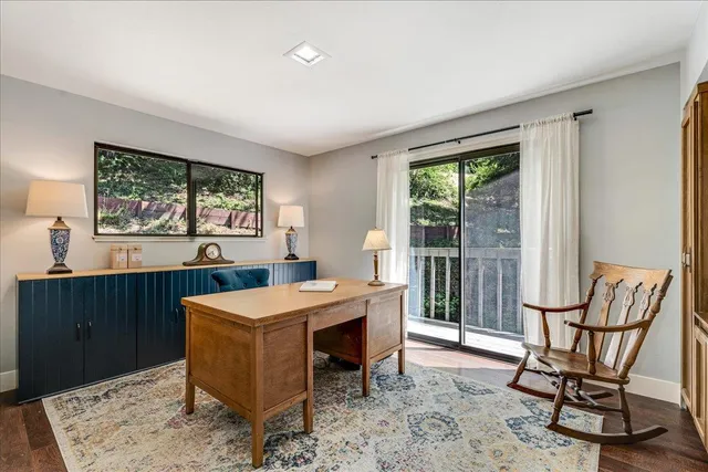 a room with furniture a window and white walls