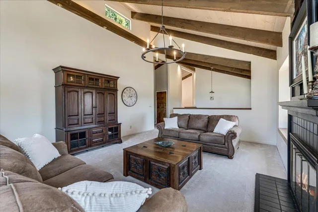 a living room with furniture a rug and a window