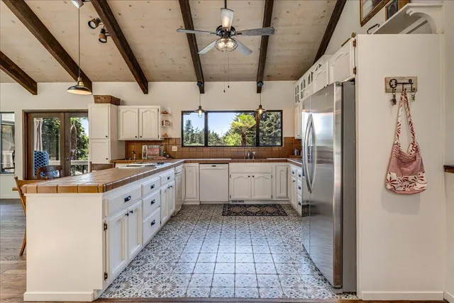 a kitchen with stainless steel appliances granite countertop a sink and cabinets