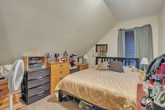 a bedroom with a bed and with furniture