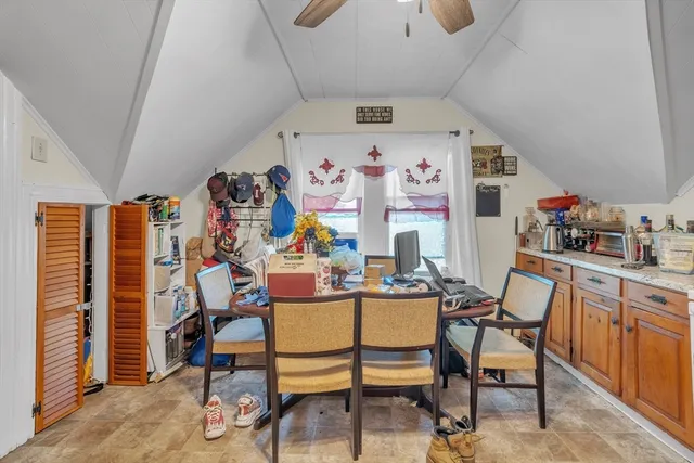 a view of a workspace with furniture and a kitchen