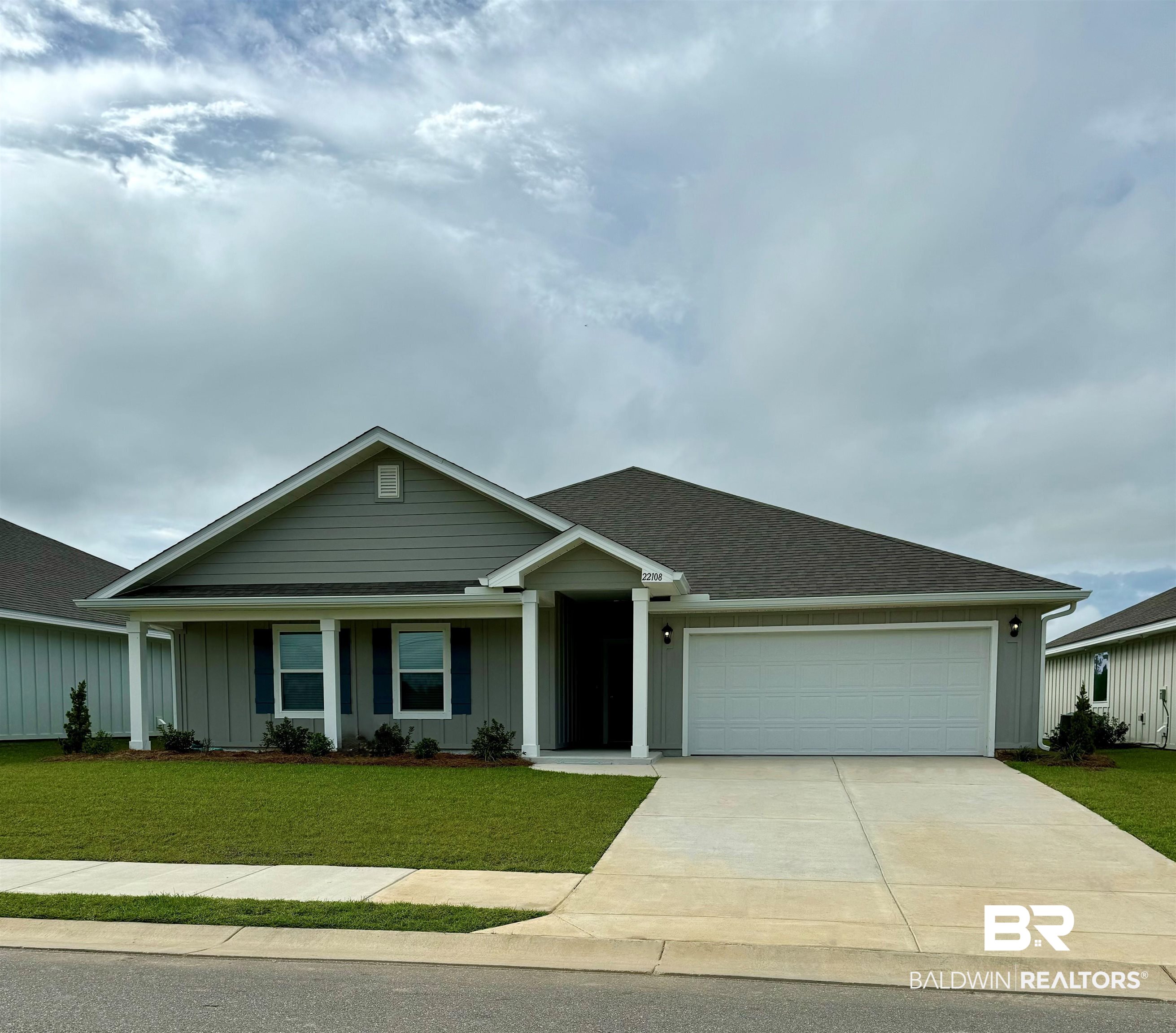 22108 Aleutian Avenue Foley, AL 36535 - Photo 1 of 7 View of front of property with a garage and a front yard