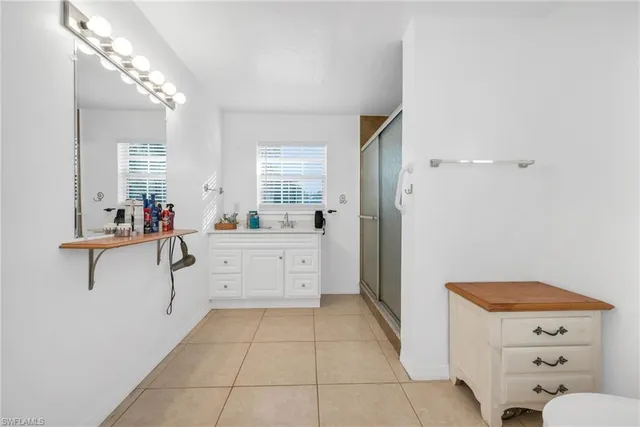 a room with a sink vanity and mirror
