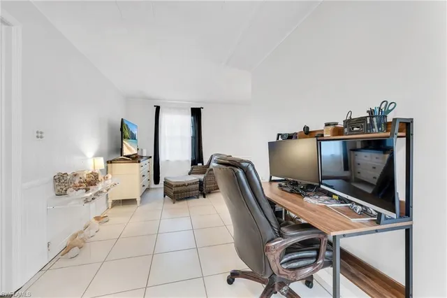 a bedroom with furniture and a flat screen tv