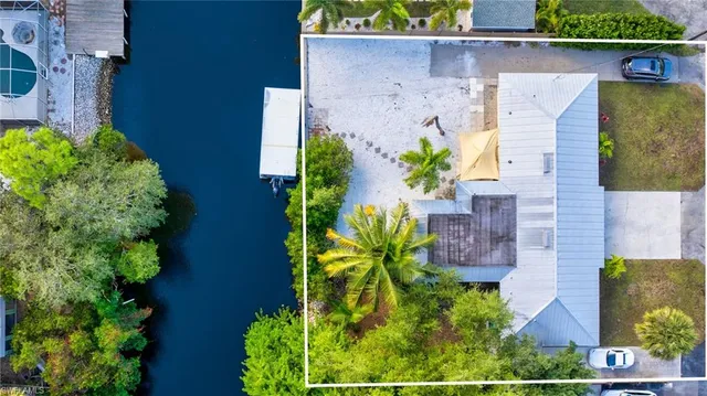 an aerial view of a house with a yard and garden in the back