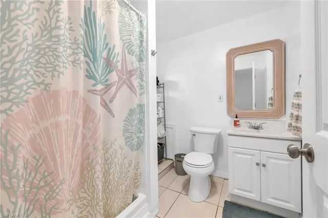 a bathroom with a toilet a sink and garden