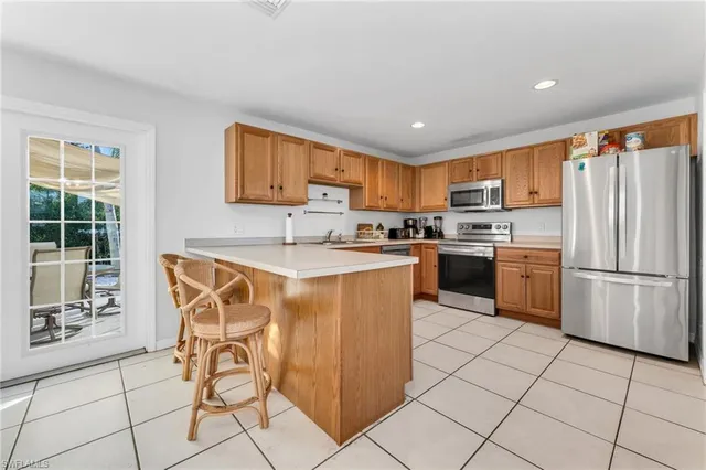 a kitchen with stainless steel appliances granite countertop a stove a sink a microwave and a refrigerator