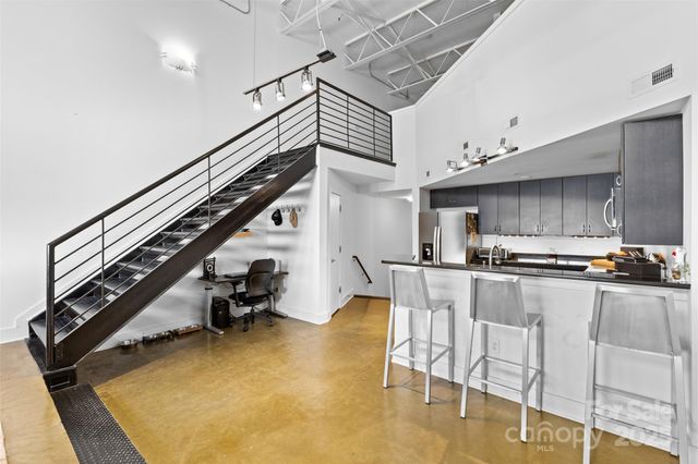 a kitchen with table chairs and a stove