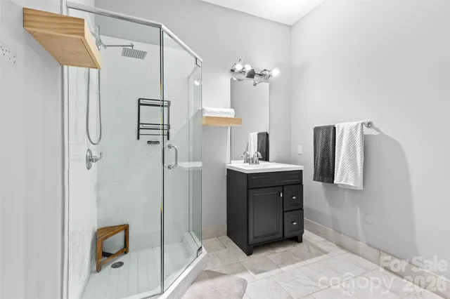 a bathroom with a double vanity sink mirror and shower