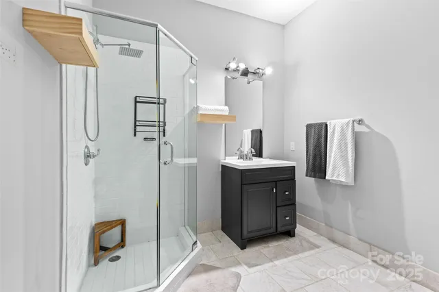 a bathroom with a double vanity sink mirror and shower