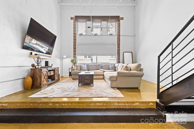 a living room with fireplace furniture and a flat screen tv
