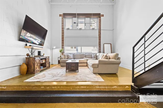 a living room with fireplace furniture and a flat screen tv
